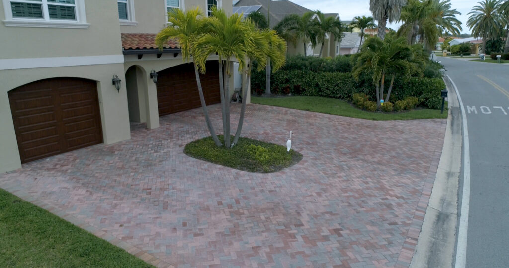 An image of a large driveway with red pavers.