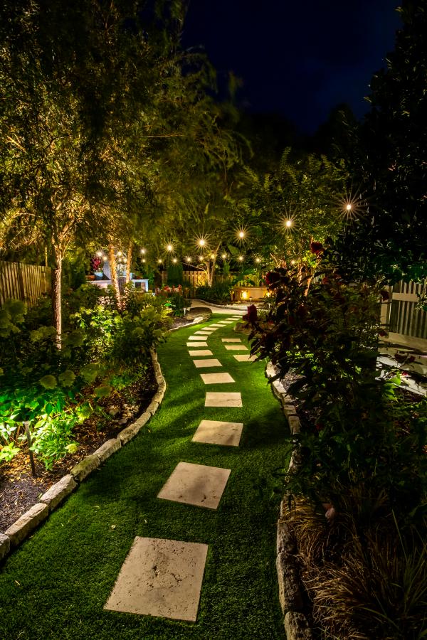 An image of a beautiful backyard with warm outdoor lighting ambience.
